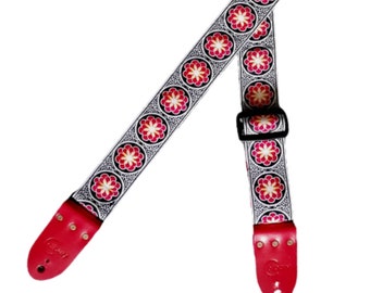 Handmade guitar strap. Red and Black embroidered flower Ribbon with Red Seatbelt backing and Red Leather ends.