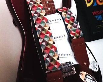 Handmade guitar strap. Multicolored 3D Squares design with black Seatbelt backing. Finished with Montana Hazelnut colour Real Leather ends.