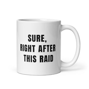 May include: White ceramic coffee mug with black text that reads "SURE, RIGHT AFTER THIS RAID".