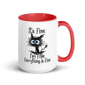 May include: White ceramic coffee mug with a red rim and handle. The mug features a black and white cartoon cat with the text "It's Fine I'm Fine Everything Is Fine."