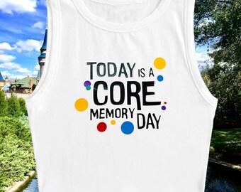 May include: White sleeveless crop top with the text "TODAY IS A CORE MEMORY DAY" in black with colorful dots around the text.
