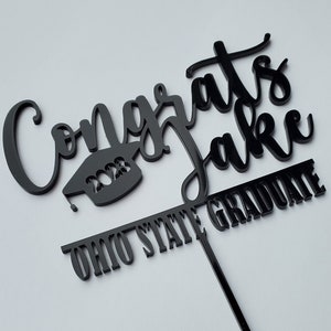 Graduation cake topper acrylic with school and graduate name.  2023 college or high school graduate cake topper