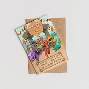May include: A colorful birthday invitation featuring cartoon dinosaurs and cowboys. The invitation reads "Grace is turning 2" and includes event details. The invitation is on a light brown envelope.