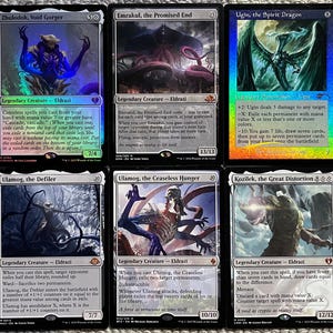 May include: Six Magic: The Gathering trading cards featuring Eldrazi creatures and Ugin, the Spirit Dragon. The cards are Zhulodok, Void Gorger, Emrakul, the Promised End, Ugin, the Spirit Dragon, Ulamog, the Defiler, Ulamog, the Ceaseless Hunger, and Kozilek, the Great Distortion.