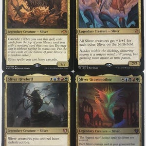 May include: Four Magic: The Gathering cards featuring Sliver creatures. The cards have a black border with gold accents and include the names "The First Sliver", "Sliver Legion", "Sliver Hivelord", and "Sliver Gravemother". Each card has unique artwork.