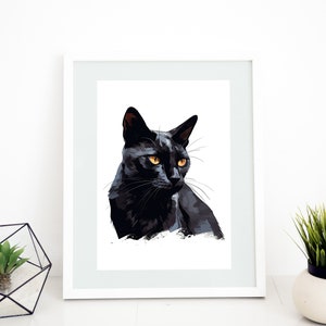 Könnte beinhalten: Ein gerahmter Druck eines schwarzen Katers mit gelben Augen. Die Katze schaut nach rechts im Bild. Der Druck ist auf weißem Hintergrund und in einem weißen Rahmen gerahmt.