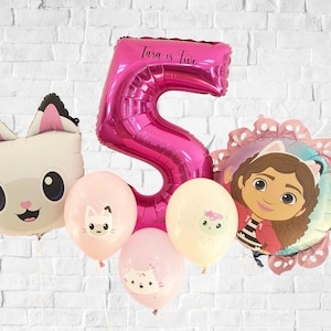 May include: A collection of birthday balloons, including a large pink number 5 balloon with the text "Tara is five". Other balloons include a cat face, three smaller balloons with cat faces, and a character balloon.