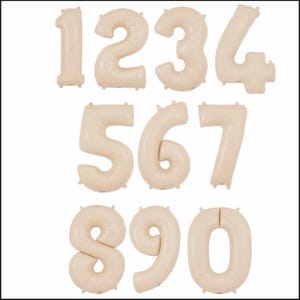 May include: A collection of beige number balloons, including the numbers 0 through 9. Each balloon is inflated and has a matte finish. These balloons are suitable for birthday parties, anniversaries, or other celebratory events.