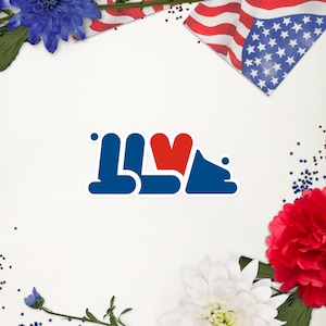 May include: A blue and red sticker with the word "I LOVE" in a stylized font. The heart is red and the letters are blue. The sticker is on a white background.