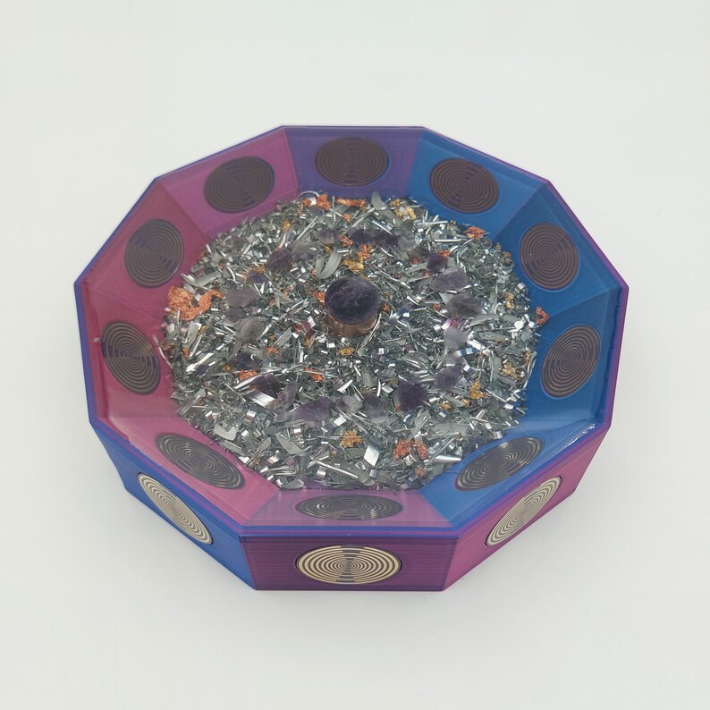 May include: Octagonal resin tray with a purple and blue swirl design. The tray is filled with silver metal shavings, purple crystals, and orange flower petals. A small purple crystal sits in the center of the tray.