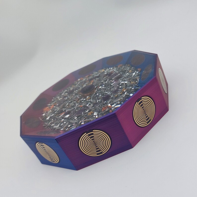 May include: Octagonal resin art piece with a purple and blue gradient. The top features a circular design with embedded metallic flakes. The sides have gold spiral designs.