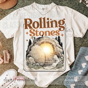 以下が含まれることがあります： 「Rolling Stones」の文字が茶色で描かれたクリーム色のTシャツ。内部から明るい光を発する墓のイラストが特徴です。デザインには十字架、木、石が含まれています。このシャツはデジタルダウンロードコレクションの一部です。