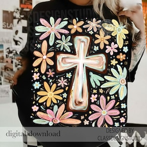 May include: Black t-shirt featuring a floral and cross design. The design includes a large cross in the center, surrounded by colorful flowers in shades of pink, yellow, and blue. The words "digital download" are at the bottom.