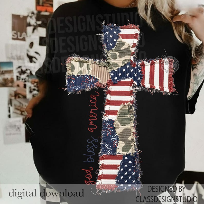 May include: Black crew neck t-shirt featuring a large cross design made of patchwork fabric. The cross incorporates elements of the American flag, camouflage, and fireworks patterns. The words "god bless america" are printed vertically on the left side.