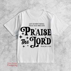 May include: White t-shirt with black text that reads "Let everything that has breath Praise the Lord Psalm 15:06".
