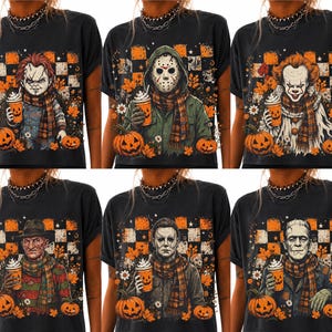 May include: A black t-shirt featuring a graphic print of six horror movie characters, each wearing a plaid scarf and holding a pumpkin-themed coffee cup. The background includes a checkered pattern, autumn leaves, and small pumpkins.