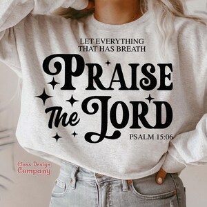 May include: A gray sweatshirt with the text "Let everything that has breath Praise the Lord Psalm 15:06" in black retro-style lettering.