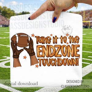 May include: White graphic featuring a football and hands catching it, with the text "Take it to the ENDZONE TOUCHDOWN!". The design includes orange stars and is set against a green field background.