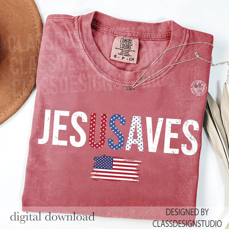 May include: A red t-shirt with the words "JESUS SAVES" in white, red, and blue. The design includes an American flag graphic. The shirt has a crew neck and short sleeves. The text "digital download" and "DESIGNED BY CLASSDESIGNSTUDIO" are also visible.