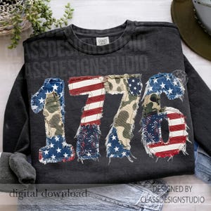 May include: Dark gray sweatshirt with the number "1776" appliqued on the front. The numbers are made of fabric with American flag, camouflage, and firework patterns. The text "digital download" and "designed by classdesignstudio" are also visible.
