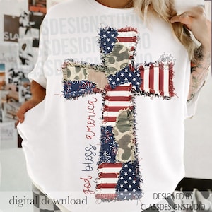 May include: White t-shirt featuring a cross design made of patchwork fabric with American flag and camouflage patterns. The words "god bless america" are written vertically on the left side of the cross. The words "digital download" are at the bottom left.