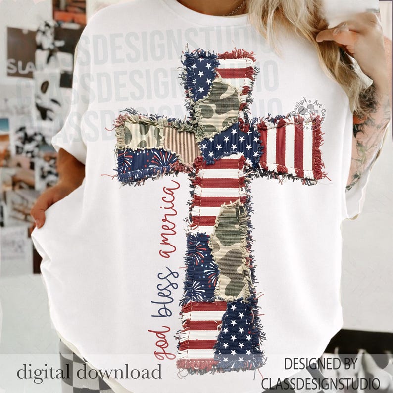May include: White t-shirt featuring a cross design made of patchwork fabric with American flag and camouflage patterns. The words "god bless america" are written vertically on the left side of the cross. The words "digital download" are at the bottom left.