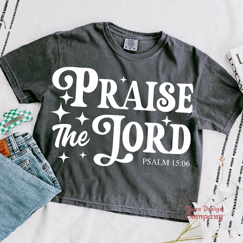 May include: A dark gray t-shirt with a white graphic that says "Praise the Lord" with stars and the text "Psalm 15:06".