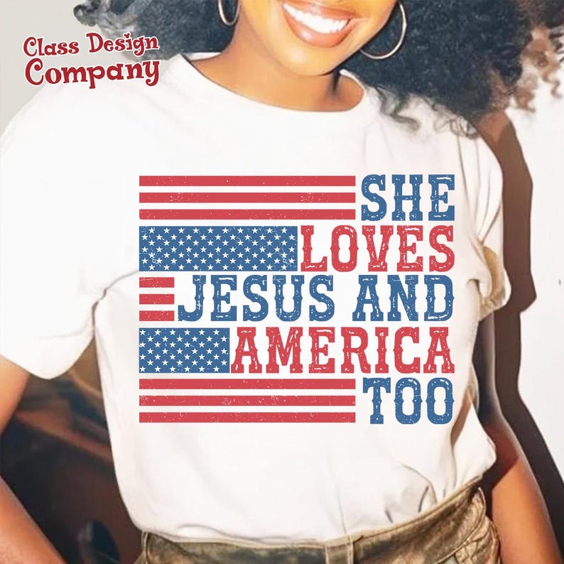 May include: White t-shirt featuring a red, white and blue American flag design. The text "She Loves Jesus and America Too" is printed on the shirt.
