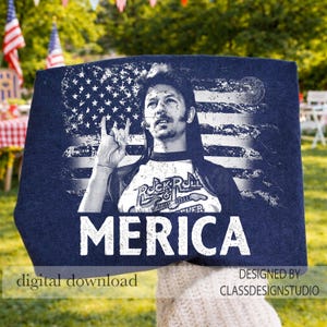 May include: Navy blue t-shirt with a graphic of a person making a hand gesture in front of a distressed American flag. The shirt has the word "MERICA" in large white letters and the words "Rock & Roll Forever".