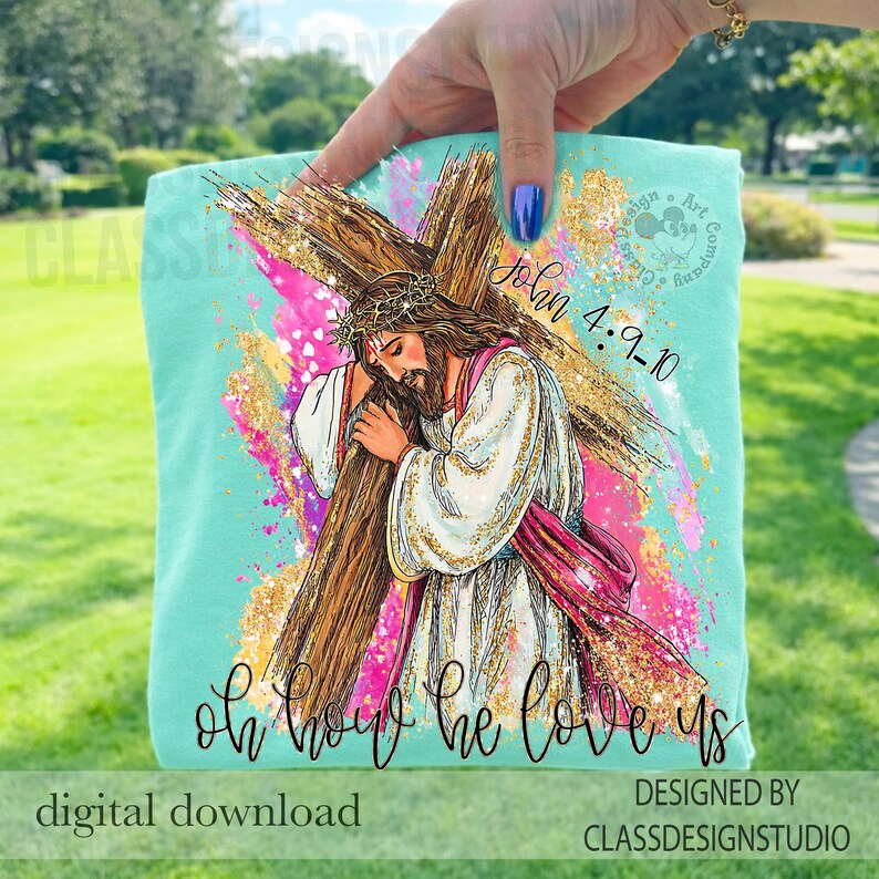May include: A light teal t-shirt featuring a graphic of Jesus carrying a cross, with the text "John 4:9-10" and "Oh how he loves us". The design includes pink, gold, and white accents. The words "digital download" are also visible.