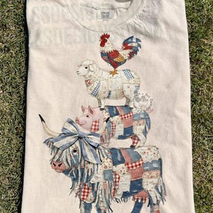 May include: A set of three ceramic mugs with a speckled, matte finish. The mugs are in shades of cream, light gray, and dark gray. Each mug has a simple, minimalist design and a rounded handle.