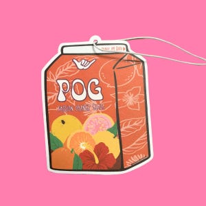 May include: A car air freshener shaped like a juice box with the words "POG Passion Orange Guava" printed on it. The juice box is orange and has a floral pattern with a hibiscus flower and slices of orange, guava, and passion fruit.