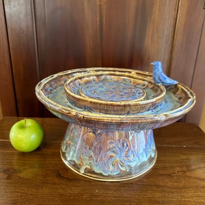 Wheel thrown ceramic bird bath on a pedestal, with a bluebird!