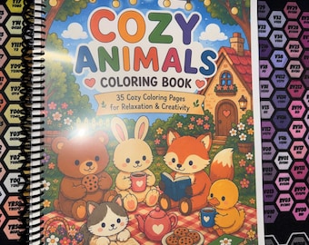 May include: A spiral-bound coloring book titled Cozy Animals Coloring Book with 35 Cozy Coloring Pages for Relaxation & Creativity by Dez Dream Studio. The cover features a bear, rabbit, fox, cat, and duck having a picnic near a cottage.