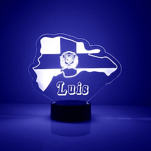 May include: A white acrylic night light shaped like the island of Puerto Rico with the name "Luis" and the Puerto Rican flag in the center.
