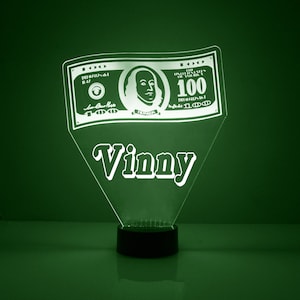 May include: A green LED night light shaped like a $100 bill with the name "Vinny" written below it.