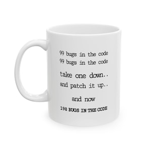 May include: White ceramic mug with a curved handle. The mug features black text that reads "99 bugs in the code, take one down, and patch it up, and now 198 BUGS IN THE CODE."