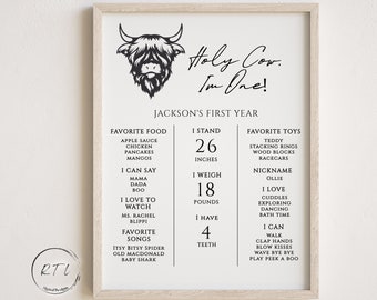 May include: A black and white printable poster with the text "Holy Cow, I'm One!" and a cute Highland cow illustration. The poster lists a baby's first year milestones, including favorite foods, toys, songs, and physical development. The poster is perfect for a baby's first birthday.