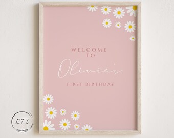 May include: A pink printable sign with white daisies and the text "Welcome to Olivia's First Birthday".