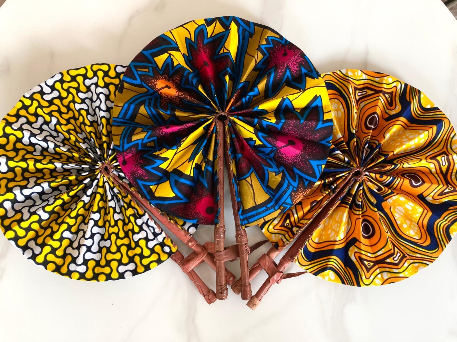 Set of 3 Ankara fabric  folding handmade fan with leather handle.