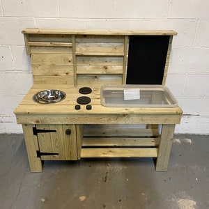 Planed and pressure treated messy play mud kitchen with built in cupboard