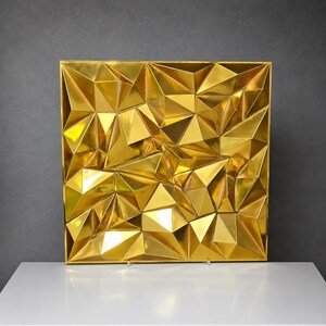 May include: A square wall art piece featuring a reflective gold finish with a three-dimensional geometric surface composed of numerous triangular facets of varying sizes and angles, creating a complex, multifaceted, and metallic appearance.