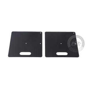 May include: Two black rectangular metal plates with rounded corners and a cut-out handle in the center. The plates are designed for use as a base for a cake stand.