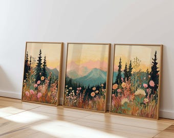May include: Three framed prints of a mountain landscape with a field of flowers in the foreground. The mountains are painted in shades of blue and green, with a pink sunset sky. The flowers are in shades of pink, white, and yellow.