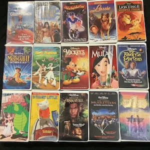 May include: A collection of Disney VHS tapes featuring animated classics like "The Lion King II: Simba's Pride," "Mulan," and "The Little Mermaid II: Return to the Sea." Other titles include "James and the Giant Peach" and "The Jungle Book."