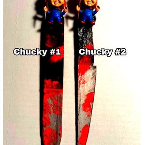 includes : A handmade Chucky knife bookmark. The bookmark is approximately 8 inches tall and features two hand painted design resembling  bloody knifes . A small Chucky figurine is attached to the top. The colors include black, red, and silver paint splatters on a black knife shaped bookmark. The bookmark is a unique and collectible item for horror fans. choose version one or version two these are unique so they will vary every time I make them