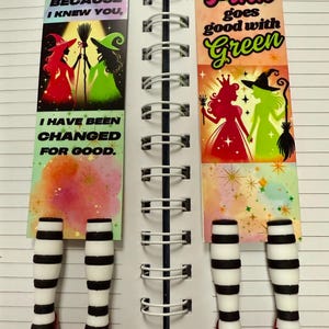 May include: Two colorful bookmarks with a witch and a princess theme. The bookmarks feature the text "Because I knew you" and "Pink goes good with Green". The bookmarks have black and white striped legs and red shoes.
