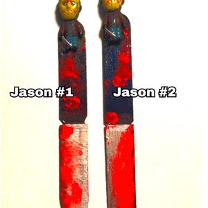 includes : A handmade Jason  knife bookmark. The bookmark is approximately 8to 9  inches tall and features two hand painted design resembling  bloody knifes . A small Jason  figurine is attached to the top. The colors include black, red, and silver paint splatters on a black knife shaped bookmark. The bookmark is a unique and collectible item for horror fans. choose version one or version two these are unique so they will vary every time I make them- choose from version one or two