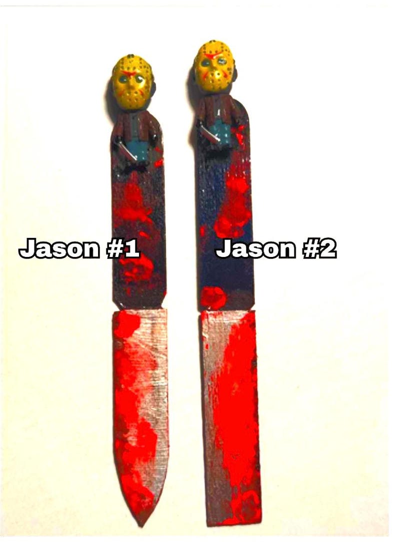 includes : A handmade Jason  knife bookmark. The bookmark is approximately 8to 9  inches tall and features two hand painted design resembling  bloody knifes . A small Jason  figurine is attached to the top. The colors include black, red, and silver paint splatters on a black knife shaped bookmark. The bookmark is a unique and collectible item for horror fans. choose version one or version two these are unique so they will vary every time I make them- choose from version one or two