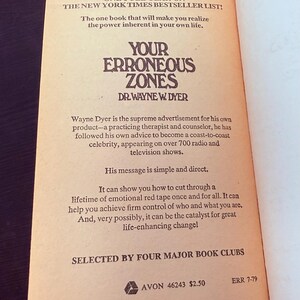 May include: Open book page with text from "Your Erroneous Zones" by Dr. Wayne Dyer. The book is a bestseller, with text in a serif font on an aged paper background. The book's title is in a bold, stylized font.